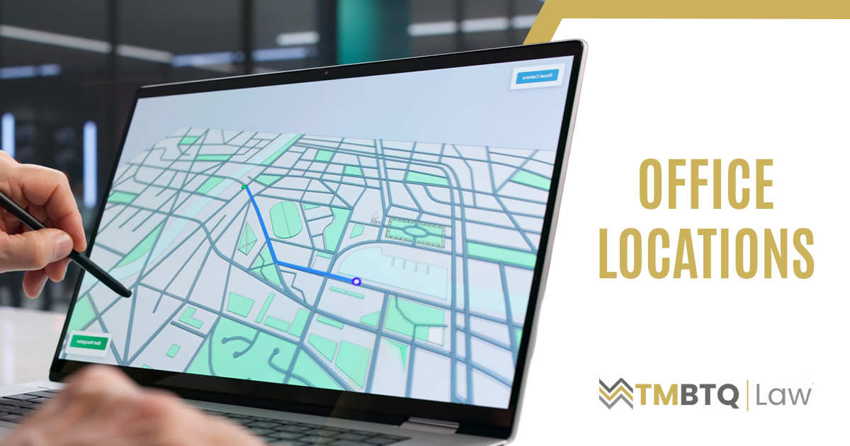 Office Locations Man searching for property locations on a laptop, representing TMBTQ Law and highlighting their office locations page to help clients easily find nearby legal services.