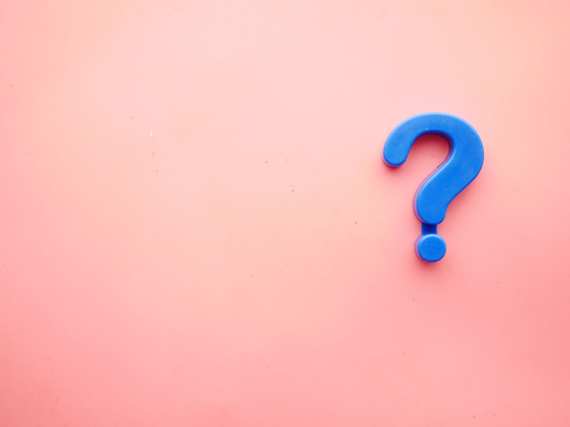 Blue 3D question mark on a pink background