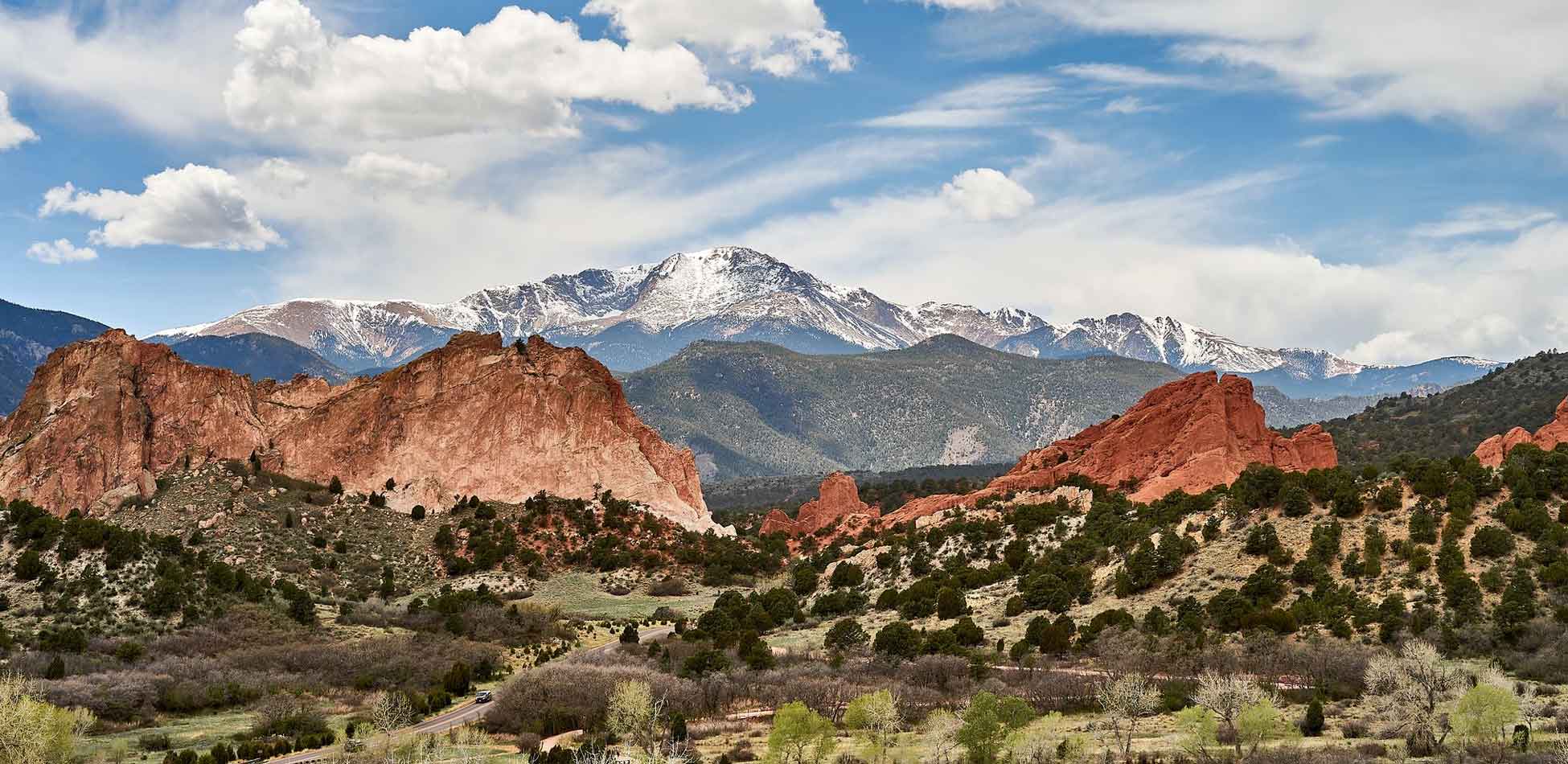 Red Rock Formations and Snowy Mountain Red sandstone rock formations in front of a snow-capped mountain