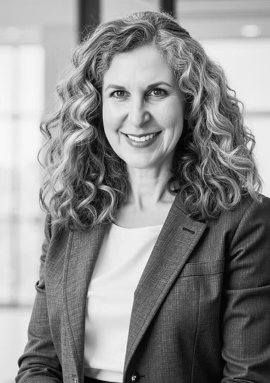 Black-and-white headshot of Tamara Pester in a dark blazer