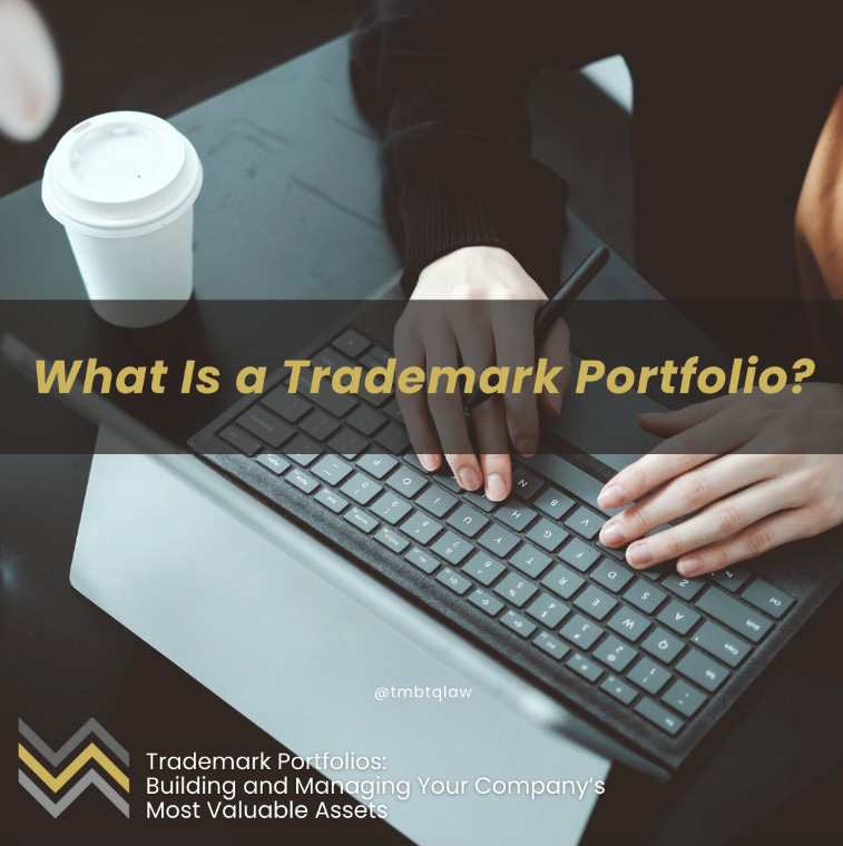 Graphic asking What Is a Trademark Portfolio? over hands typing on a laptop